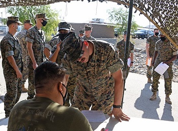 Military personnel standing in line to sign up for the flu shot