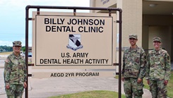 U.S. Army Lt. Col. Dr. Anna Yoo, U.S. Army Maj. Dr. Eric Hu, and U.S. Army Lt. Col. Dr. Stephanie Helmus stand outside the Billy Johnson Dental Clinic