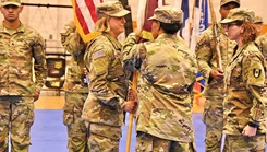 Col. Christina Buchner, commander, 44th Medical Brigade, passes the 32d Hospital Center colors to Col. Lana Bernat during a change of command ceremony 