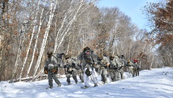 A team of airmen conducting a long-distance ruck during the Air National Guard’s cold weather operations course at Camp Ripley Training Center, Minnesota
