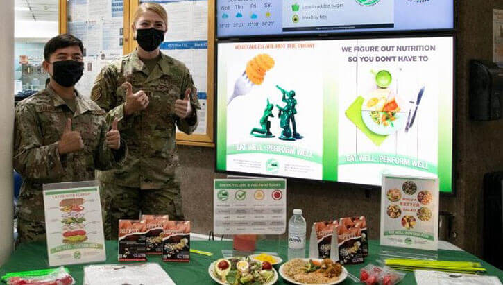Air Force Capt. Sydney Sloan, 39th Operational Medical Readiness Squadron health promotion element chief (right), and Air Force Senior Airman Gloriann Manapsal, 39th Operational Medical Readiness Squadron health promotion technician (left), promote making healthy choices at the Sultan’s Inn Dining Facility on Incirlik Air Base, Turkey.