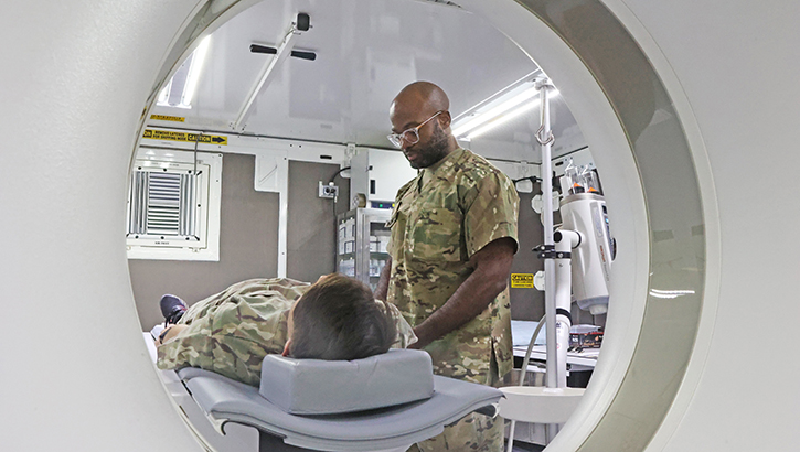U.S. Army Maj. Remy Ngwanyam, a radiologist with the 528th Hospital Center, demonstrates using the new 128-slide computed tomography scan at Camp Arifjan, Kuwait. The upgraded CT scan will greatly improve patient care with its reliability and advanced features. (Photo by U.S. Army Staff Sgt. Brina Jenkins/1st Theater Sustainment Command)
