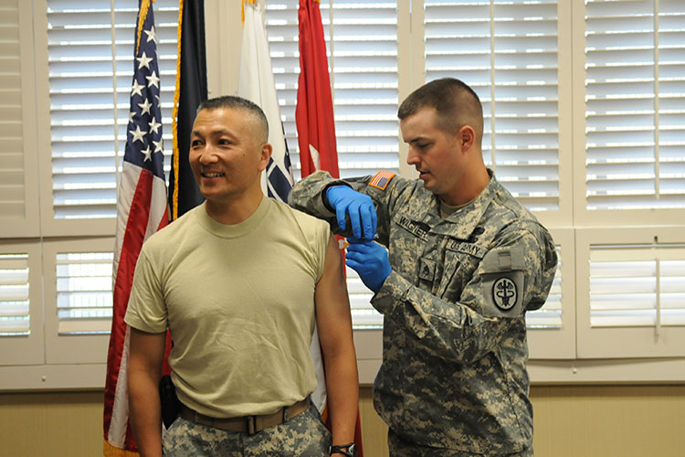 Staff Sgt. James H. Wagner, William Beaumont Army Medical Center, vaccinates Maj. Gen. M. Ted Wong, commanding general, William Beaumont Army Medical Center, with the seasonal flu vaccines. All WBAMC beneficiaries are encouraged to get vaccinated against the seasonal flu vaccine and the novel flu virus. Look for flu updates on the WBAMC Facebook page, the All Bliss and the Fort Bliss Monitor. (Photo by SGT Valerie Lopez)