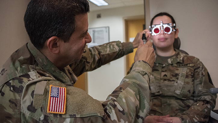 Image of U.S. Army Col. (Dr.) Frank Valentin, chief of ophthalmology, checks a patient for double vision and convergence at Brooke Army Medical Center, Fort Sam Houston, Texas. Recruiting qualified health care providers across the MHS is the first step in the stabilization of MHS, aligning with the MHS Strategy.  (U.S. Army photo by Jason W. Edwards).