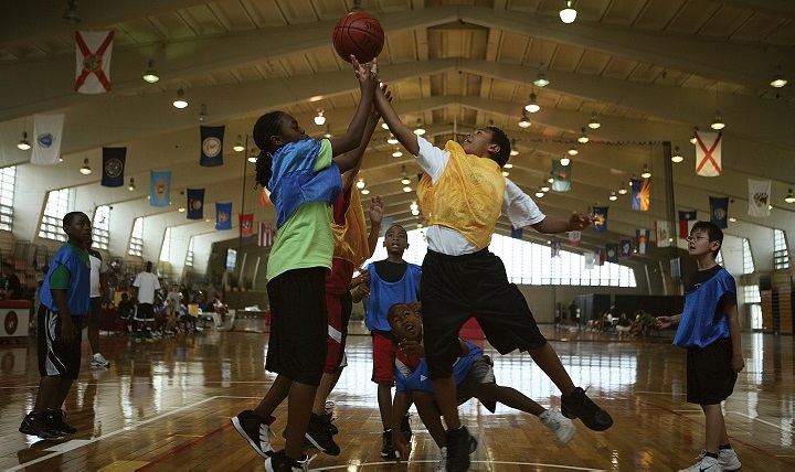 Kianna McWaite, left, 10, and Anthony Underwood, right, 10, fight for a rebound during the semi-final game of a basketball tournament. The two-day tournament concluded the week-long basketball camp. Research has shown that obese children are more likely to be overweight or obese as adults. Children should get at least 1 hour of physical activity per day. (U.S. Marine Corps photo by Lance Cpl. Mark Stroud)
