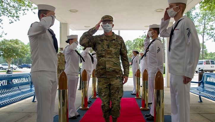 Image of Lt. Gen. Ronald Place saluting to soldiers.