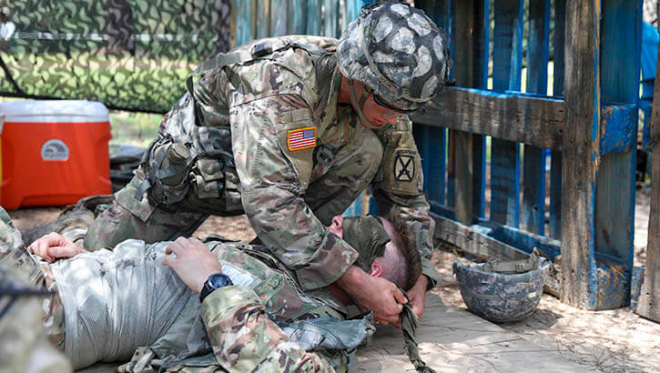 Pvt. Second Class Jagger Dixon, treats an eye injury during Expert Infantryman Badge testing, June 15, 2021, at Fort Polk, Louisiana. Dixon is a soldier with B Company; 2nd Battalion, 4th Infantry Regiment, 3rd Brigade Combat Team, 10th Mountain Division. Soldiers must successfully execute a variety of warrior tasks to earn their EIB. (Photo: Army Spc. Kay Edwards, 27th Public Affairs Detachment)