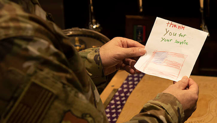 Image of soldier holding a letter. .