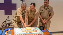 Rear Adm. Matthew Case, Acting Surgeon General Director of the Medical Service Corps, Capt. David Lang, executive officer, Navy Medicine Readiness and Training Center and Lt. Adrianna Kuechle cutting cake