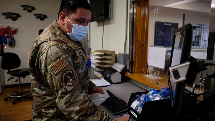Image of U.S. Air Force Tech. Sgt. Anthony Iannicello, 8th Health Care Operations Squadron, pharmacy noncommissioned officer in charge, prepares to issue medication to a patient at Kunsan Air Base, Republic of Korea, on Oct. 13, 2022. (Credit: Senior Airman Shannon Braaten 8th Fighter Wing Public Affairs).