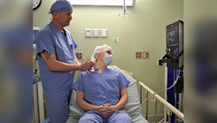 Military medical personnel administers ultrasound on patient.