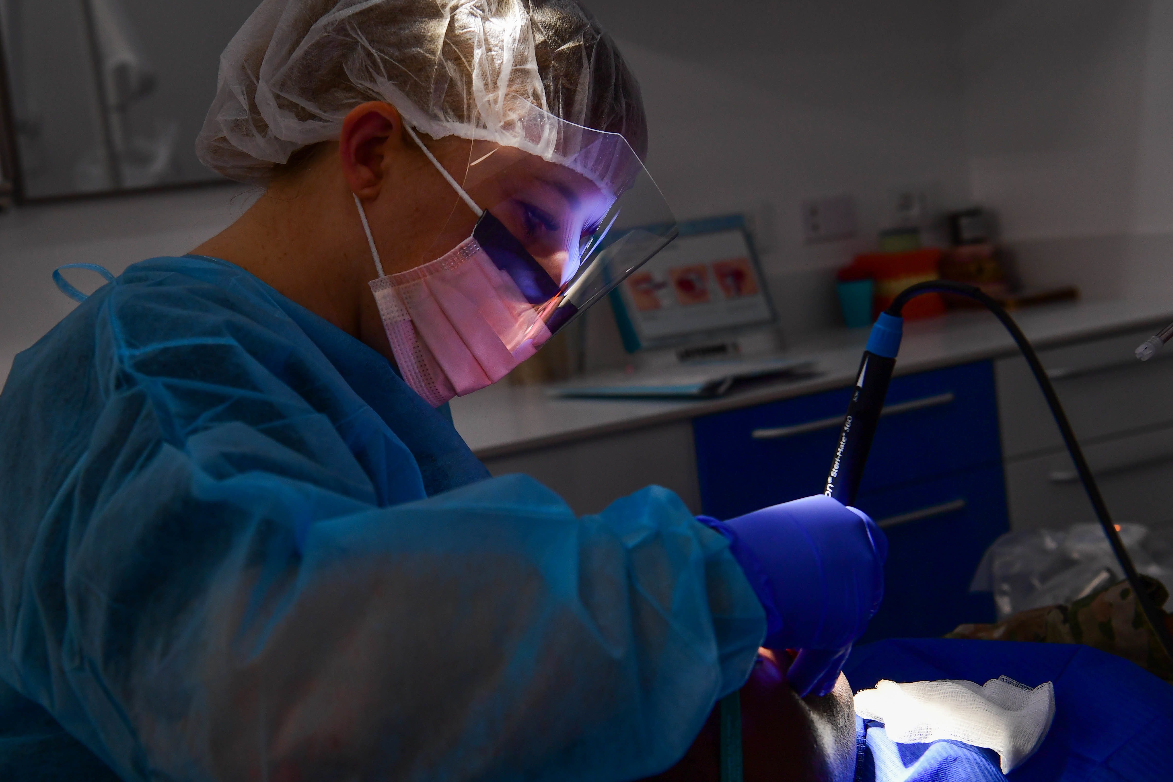 Image of Dentist performs an exam.