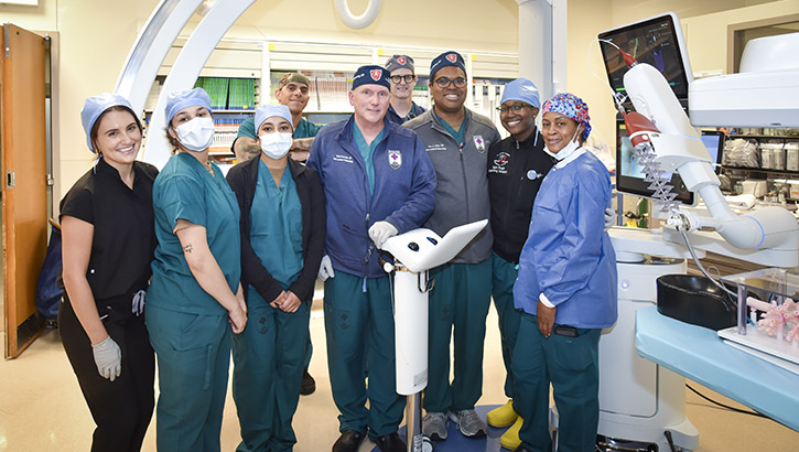 Walter Reed’s Interventional Pulmonology team gears up for first Robotic Bronchoscopy within the Defense Health Agency. Retired U.S. Navy Capt. Robert F. Browning (1st row 4th from left) and U.S. Navy Capt. Sean McKay (1st row 5th from left). (Photo: James Black)