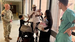 U.S. Army Col. William F. Bimson, director of Tripler Army Medical Center (TAMC), speaks with U.S. Army Staff Sgt. Yeni A. Conquest, center right, a mortuary affairs non-commissioned officer with 8th Theater Sustainment Command (8th TSC), and U.S. Navy Petty Officer 2nd Class Blake A. Conquest, center left, an aviation electronics technician with Marine Aviation Logistics Squadron 24