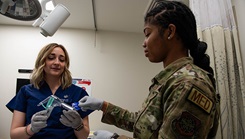 U.S. Air Force Maj. Keri Ellard, left, 60th Inpatient Operations Squadron health clinic OB-GYN physician, demonstrates how to prepare a speculum for a simulated medical procedure to U.S. Air Force Airman 1st Class Jordan Whitmore, 60th IPTS medical technician, at David Grant USAF Medical Center at Travis Air Force Base, California, Jan. 26, 2024. On Sept. 23, 2024, the Department of Defense announced its commitment to continue advancing women's health research through Congressionally Directed Medical Research Programs. Funding opportunities encourage applicants to consider research into health areas that affect women and support innovators engaged in research and development on women’s health. (U.S. Air Force photo by Kenneth Abbate) 