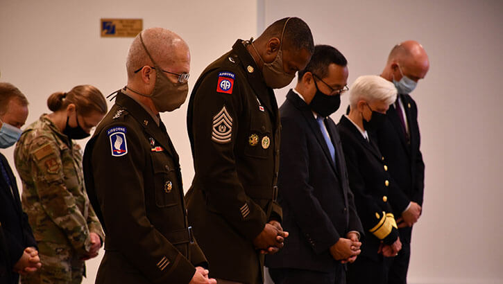 Defense Health Agency Director Army Lt. Gen. (Dr.) Ronald Place and Command Sgt. Maj. Michael Gragg bow their heads for the invocation prayer during a ceremony marking the 20th anniversary of the terrorist attacks on September 11, 2001, at DHA headquarters in Falls Church, Virginia, Sept. 10.
