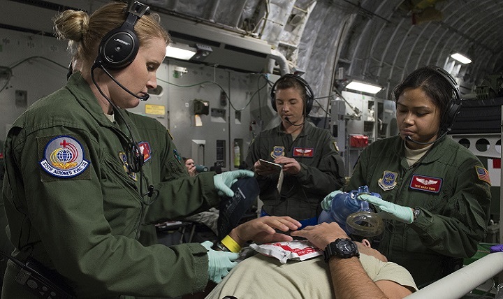 An aeromedical evacuation expert practices on a patient during a collaborative Air Mobility Command training initiative.