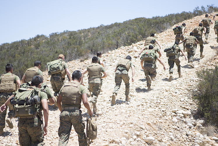 U.S. Marines sprint uphill during a field training exercise at Marine Corps Air Station Miramar, California. to maintain contact with an aviation combat element, teaching and sustaining their proficiency in setting up and maintaining communication equipment.  (Photo Courtesy: U.S. Marine Corps)
