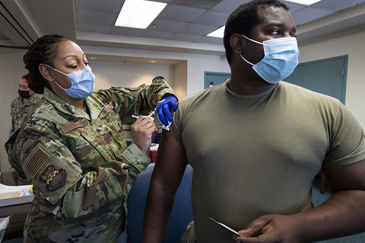 Image of Capt. Shamira Conerly, 149th Medical Group, gives Staff Sgt. Timmy Sanders, 149th Maintenance Squadron, his first dose of COVID-19 vaccine. Click to open a larger version of the image.