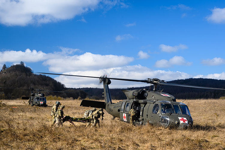 Image of U.S. Army Soldiers from the 115th Brigade Support Battalion, 1st Armored Brigade Combat Team, evacuate casualties onto waiting HH-60M MEDEVAC Blackhawk helicopters from Charlie Company, 6th Battalion, 101st Combat Aviation Brigade during Combined Resolve XV, Feb. 27, 2021, at Hohenfels Training Area. Combined Resolve XV is a Headquarters Department of the Army directed Multinational exercise designed to build 1st Armored Brigade Combat Team, 1st Cavalry Division’s readiness and enhance interoperability with allied forces and partner nations to fight and win against any adversary.(U.S. Army photo by Sgt. 1st Class Garrick W. Morgenweck).