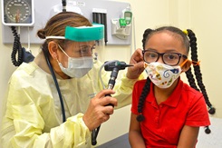 MAYPORT, Fla. (Sept. 18, 2020) – Cmdr. Mary Gracia, a pediatric nurse practitioner at Naval Branch Health Clinic Mayport, checks five-year-old Gabriella’s ears. Gracia, a native of McAllen, Texas, says, “It's been an honor and a privilege to impart my expertise to the children of our active duty members who are graciously serving our country. These children, our future leaders, prayers lifted and bountiful blessings for each one. And to the children I've helped during overseas deployments, prayers continued.” (U.S. Navy photo by Jacob Sippel, Naval Hospital Jacksonville/Released).