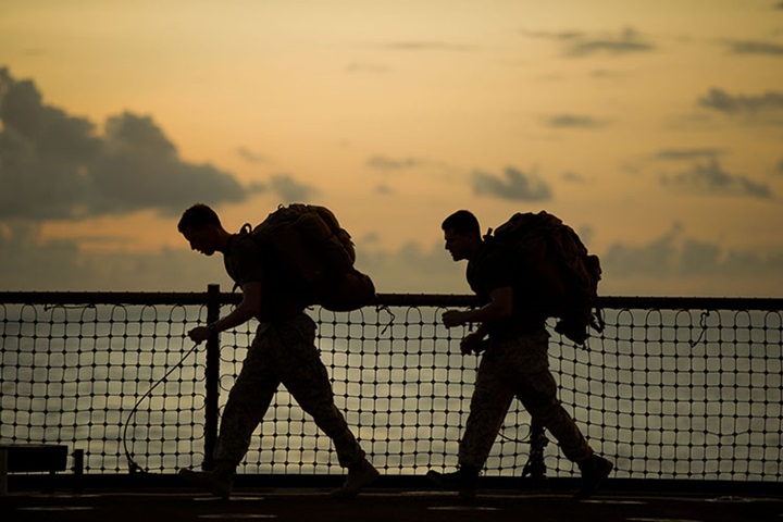 Image of Navy Lt. James E. Lamb, left, and Sgt. Ryan Eskandary exercise aboard USS Pearl Harbor.