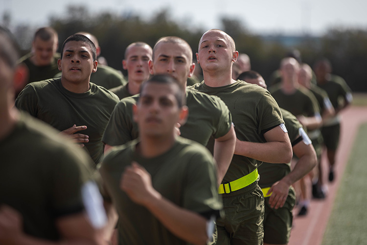 Image of Marine Corps Recruit Depot, San Diego  Recruits with Bravo Company, 1st Recruit Training Battalion, hydrate after a physical training session. Click to open a larger version of the image.