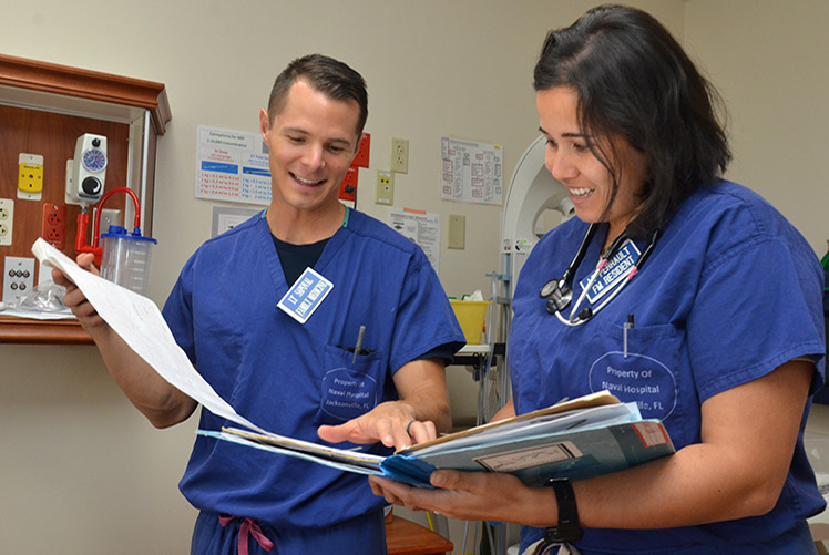 Naval Hospital Jacksonville physicians Lt. Catherine Perrault, right, and Lt. Joseph Sapoval review patient charts at the hospital’s labor and delivery unit. Perrault, from Orlando, Florida, rendered aid at the scene of an accident involving a train and a school bus on Sept. 27, 2018. Perrault recently returned from a deployment to the Middle East where she served as the general medical officer aboard the amphibious assault ship USS Iwo Jima (LPH 2). During the deployment, she provided routine, acute, and critical care. (U.S. Navy photo by Jacob Sippel/Released)