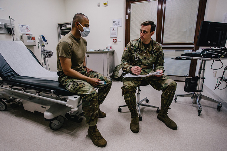 A U.S. Army nurse paratrooper provides patient care in support of preventative efforts against COVID-19
