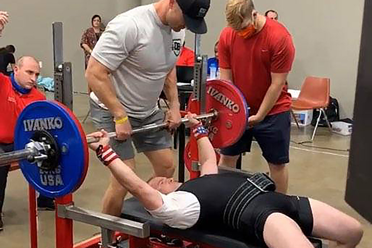Image of Master Sgt. Daniel Bedford prepares to pump up a gold medal lift in the bench press during the United States Powerlifting Association 2020 Texas State Bench Press Championship.