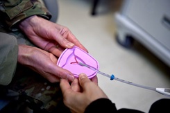 Hands holding an intrauterine device