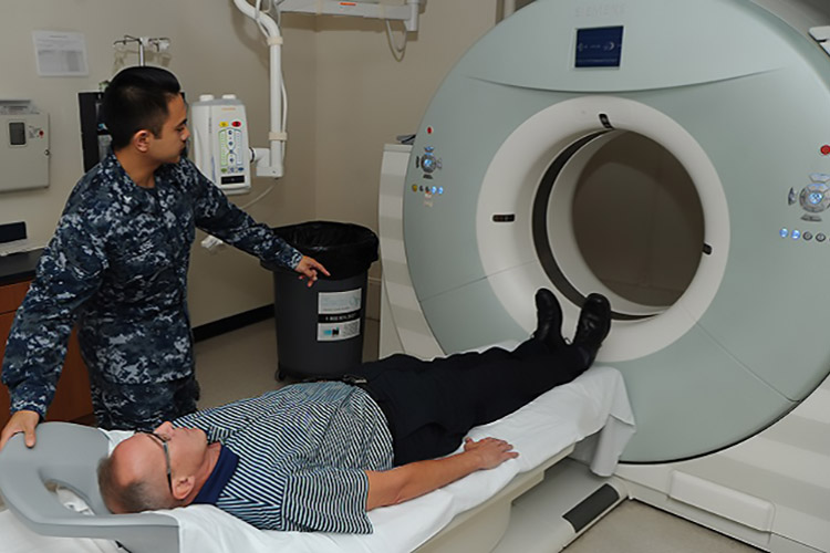 A patient at Naval Hospital Pensacola prepares to have a low-dose computed tomography test done to screen for lung cancer. Lung cancer is the leading cause of cancer-related deaths among men and women. Early detection can lower the risk of dying from this disease. (U.S. Navy photo by Jason Bortz)