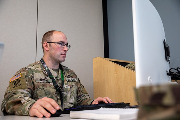 Image of NIANTIC, CT, UNITED STATES 06.16.2022 U.S. Army Staff Sgt. John Young, an information technology specialist assigned to Joint Forces Headquarters, Connecticut Army National Guard, works on a computer at Camp Nett, Niantic, Connecticut, June 16, 2022. Young provided threat intelligence to cyber analysts that were part of his "Blue Team" during Cyber Yankee, a cyber training exercise meant to simulate a real world environment to train mission essential tasks for cyber professionals. (U.S. Army photo by Sgt. Matthew Lucibello).