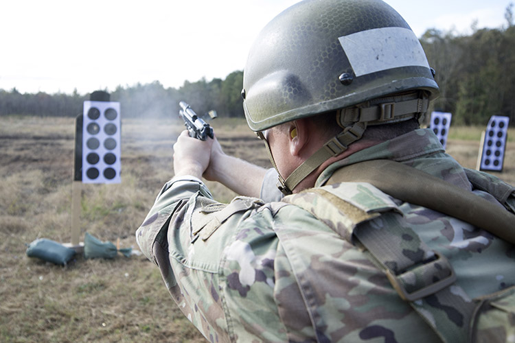 Image of A soldier fires a pistol during small arms training. Click to open a larger version of the image.