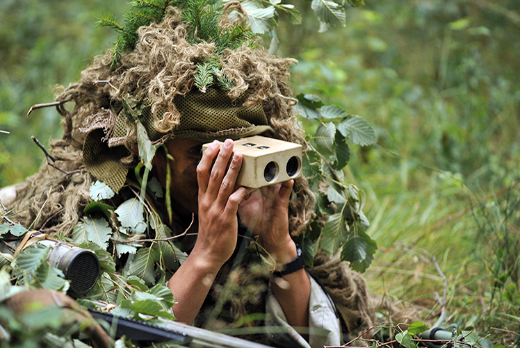 Image of A paratrooper with 1st Squadron, 91st Cavalry Regiment, 173rd Airborne Brigade lies concealed in a forest and observes his target during a combined sniper exercise with the British Army's 1st Battalion, Royal Irish Regiment as part of Exercise Wessex Storm at the 7th Army Joint Multinational Training Command's Grafenwoehr Training Area, Germany, July 30, 2015. Wessex Storm is an annual maneuver exercise for British forces, integrating NATO allies and partners. (U.S. Army photo by Visual Information Specialist Gertrud Zach/released). Click to open a larger version of the image.