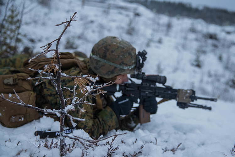 A U.S. Marine with Marine Rotational Force-Europe (MRF-E) 19.1 maintains a defensive security position during Exercise Winter Warrior in Haltdalen, Norway, Dec. 5, 2018. The three-week exercise tested the Marines' abilities to adapt to harsh weather conditions, move across long distances in the snow and push themselves to complete the mission despite austere situations. (U.S. Marine Corps photo by Cpl. Elijah Abernathy/Released)