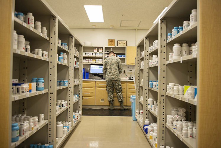 Image of U.S. Air Force Tech Sgt. Ryan Marr, 18th Medical Group pharmacy craftsman, processes prescriptions, June 8, 2018, at Kadena Air Base, Japan. The pharmacy processes and fills prescriptions for hundreds of different medical needs. (U.S. Air Force photo by Staff Sergeant Jessica H. Smith) Merriam/Released). Click to open a larger version of the image.