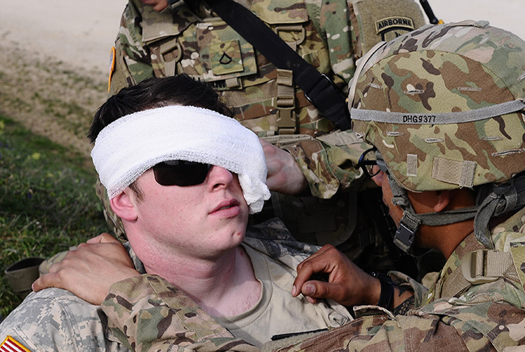 U.S. Army Spc. Angel Gomez, right, assigned to Charlie Company, 173rd Brigade Support Battalion, wraps the eye of a fellow Soldier with a simulated injury, for a training exercise as part of exercise Saber Junction 16 at the U.S. Army’s Joint Multinational Readiness Center in Hohenfels, Germany, April 5, 2016. Saber Junction is a U.S. Army Europe-led exercise designed to prepare U.S., NATO and international partner forces for unified land operations. The exercise was conducted March 31-April 24. (U.S. Army photo by Pfc. Joshua Morris)