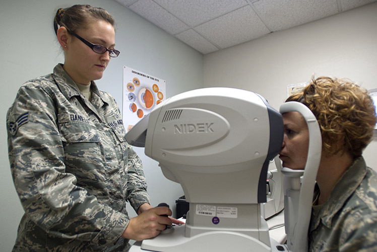 Image of Senior Airman Breanna Daniels, 559th Medical Group optometry technician, takes images of Tech. Sgt. Stephanie Edmiston, 559th MDG trainee health flight chief, during an eye exam Oct. 19 at the Reid Clinic on Joint Base San Antonio-Lackland, Texas. The 559th MDG is home to the largest optometry and public health flight in the Department of Defense; the DOD's first military training consultation service. (U.S. Air Force photo/Staff Sgt. Kevin Iinuma).