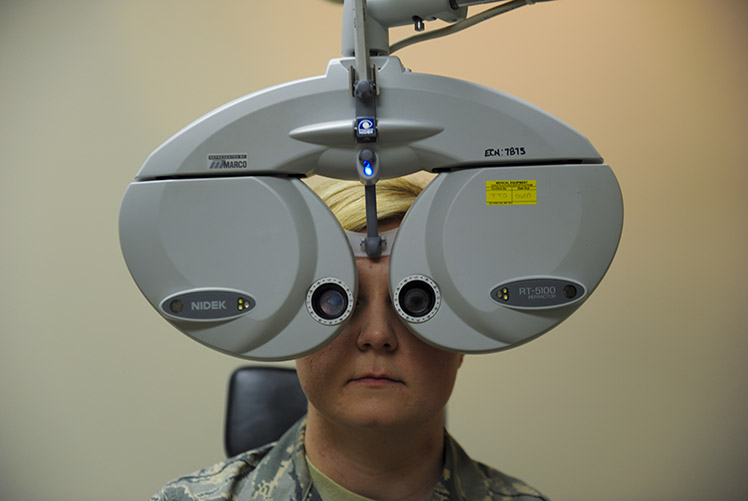 A patient looks through a phoropter at Hurlburt Field, Fla., Jan. 9, 2017. A phoropter is an instrument used to determine an individual’s eyeglass prescription by measuring the eye’s refractive error and switching through various lens until the persons vision is normal. (U.S. Air Force photo by Airman Dennis Spain)