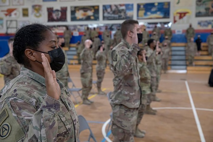 Image of U.S. Army Central Reserve component Soldiers swear the oath of enlistment during a mass reenlistment ceremony in celebration of the U.S. Army Reserve 113th birthday at Camp Arifjan, Kuwait, April 23, 2021.