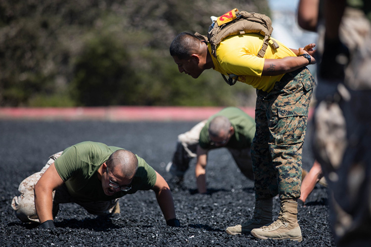 Image of A U.S. Marine Corps drill instructor with Golf Company, 2nd Recruit Training Battalion, motivates a recruit during a Marine Corps Martial Arts Program (MCMAP) training session at Marine Corps Recruit Depot, San Diego, Aug. 2, 2021. Click to open a larger version of the image.