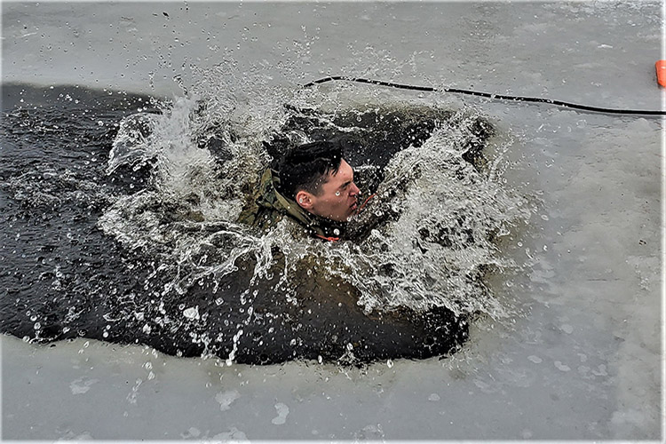 Image of A student in the army participates in a cold-water immersion training. Click to open a larger version of the image.