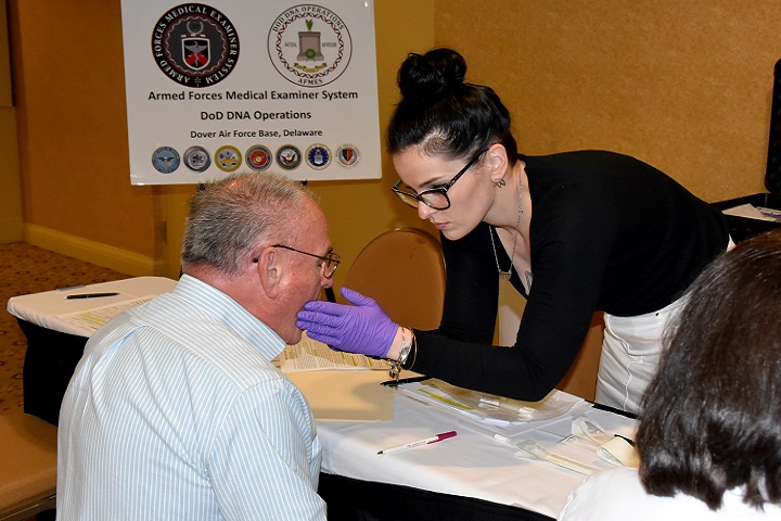 Gina Parada, Armed Forces Medical Examiner System DNA analyst, collects a DNA sample during a POW/MIA Accounting Agency Family Member Update in Louisville, Kentucky. DNA can be used to support anthropology of recovered skeletal remains or be used as primary means of identification. (U.S. Air Force photo by Tech. Sgt. Robert M. Trujillo)
