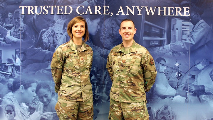 Air Force Maj. Nicole Ward (left) and Air Force Capt. Matthew Muncey, program managers with the Air Force Medical Service Transition Cell, pose for a photo at the Defense Health Headquarters in Falls Church, Virginia. (U.S. Air Force photo by Josh Mahler)