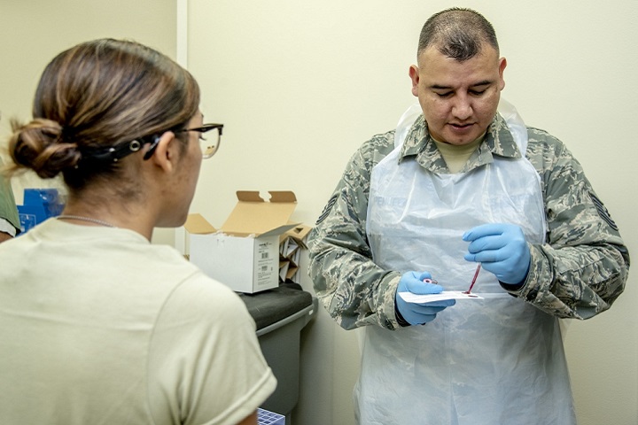 Air Force Tech. Sgt. Ricky Penuelaz, 59th Medical Wing lab technician, uses a pipette to put blood on an Air Force traineeâ€™s DNA card. The Armed Forces Medical Examiner System-Armed Forces Repository of Specimen Samples of the Identification of Remains inspected Lackland Air Force Base, Texas, on the collection of DNA cards. AFMES-AFRSSIR is responsible for managing, coordinating and maintaining the collection of DNA blood reference cards for all active duty, reserve, and National Guard service members. This is done when service members first enter the military and is collected at one of nine basic training sites, dependent on their branch of service. (U.S. Air Force photo by Staff Sgt. Nicole Leidholm)