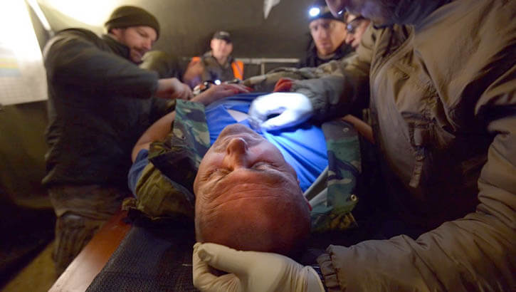 Image of a service member being treated. Click to open a larger version of the image.