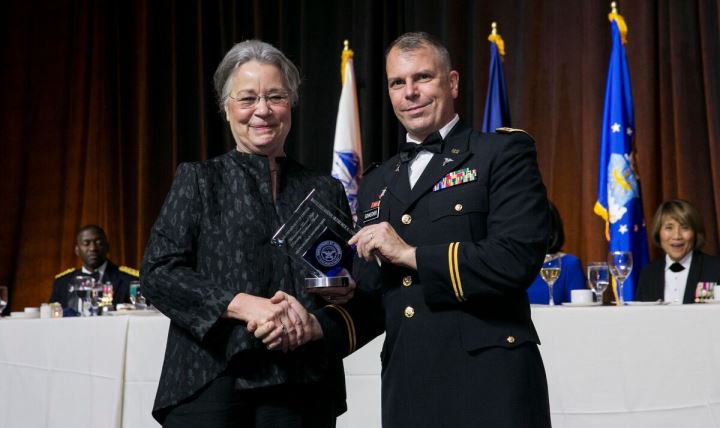Army Lt. Col. Kurt Schaecher (right), chief of the Infectious Disease laboratory at Walter Reed National Military Medical Center in Bethesda, Maryland, receives the Healthcare Excellence in Patient Safety award from Dr. Karen Guice (left), principal deputy assistant secretary of Defense for Health Affairs, performing the duties of the assistant secretary of Defense for Health Affairs, at the AMSUS (the Society of Federal Health Professionals) meeting, Dec. 1, 2016, at National Harbor near Washington, D.C. (Photo courtesy of AMSUS) 