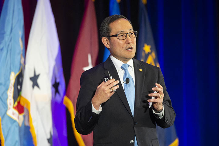 Mr. Guy Kiyokawa, deputy director of the Defense Health Agency (DHA), delivers remarks during the AMSUS 2018 DHA general session. 