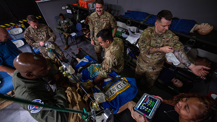 U.S. Air Force aeromedical evacuation technicians and a nurse gather for a pre-brief before clinical simulator training at Ramstein Air Base